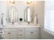 Bright bathroom features double sinks, decorative mirrors and new fixtures at 15304 Fairlands Dr, Westfield, IN 46074
