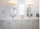 Elegant bathroom featuring double vanity with quartz countertop, gold fixtures, and framed mirrors, creating a sophisticated aesthetic at 15304 Fairlands Dr, Westfield, IN 46074