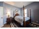Cozy bedroom features a four-poster bed, hardwood floors, and soft lighting at 15304 Fairlands Dr, Westfield, IN 46074