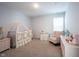 Softly lit Bedroom with crib, rocking chair, and pink accents, creating a cozy and comforting space at 15304 Fairlands Dr, Westfield, IN 46074