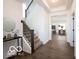 Bright entryway featuring beautiful hardwood floors and an elegant staircase leading to the upper level at 15304 Fairlands Dr, Westfield, IN 46074