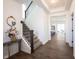 Welcoming foyer with hardwood floors, stairs, and stylish decor at 15304 Fairlands Dr, Westfield, IN 46074