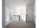 Upstairs hallway featuring neutral carpeting and black wrought iron staircase railing at 15304 Fairlands Dr, Westfield, IN 46074
