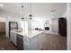 Open kitchen with large island, stainless steel appliances that opens into living room with fireplace at 15304 Fairlands Dr, Westfield, IN 46074