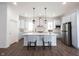 Beautiful kitchen with island seating, pendant lighting, stainless steel appliances and light cabinets at 15304 Fairlands Dr, Westfield, IN 46074