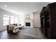 Inviting living room with fireplace, television, leather sofa and large windows for natural light at 15304 Fairlands Dr, Westfield, IN 46074