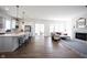 Bright, open-concept living space featuring hardwood floors, fireplace, and kitchen with island seating at 15304 Fairlands Dr, Westfield, IN 46074