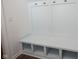 A well-organized mudroom features a built-in bench and hooks for efficient storage at 15304 Fairlands Dr, Westfield, IN 46074