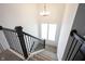 Elegant staircase with dark wood railing and carpeted steps leading to the upper level at 15304 Fairlands Dr, Westfield, IN 46074