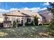 Inviting backyard with a well-maintained lawn, mature trees, and a charming brick exterior with ample natural light at 1621 Rosebud Ln, Greenwood, IN 46143