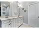 Bathroom featuring double sinks, marble countertops, custom cabinets, and decorative wall accents at 1621 Rosebud Ln, Greenwood, IN 46143