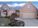 Charming brick home with well-manicured landscaping and a two-car garage at 1621 Rosebud Ln, Greenwood, IN 46143