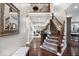 Open foyer with staircase, hardwood floors, and a view into the living room at 1621 Rosebud Ln, Greenwood, IN 46143