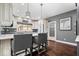 Bright kitchen with white cabinets, island seating, and hardwood floors at 1621 Rosebud Ln, Greenwood, IN 46143