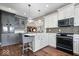 Stylish kitchen with gray and white cabinetry, hardwood floors, and stainless appliances at 1621 Rosebud Ln, Greenwood, IN 46143