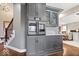 Kitchen with gray cabinets, stainless steel oven, and hardwood floors at 1621 Rosebud Ln, Greenwood, IN 46143