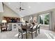 Open living area with vaulted ceilings, large windows, fireplace, built-in shelving and dining table at 1621 Rosebud Ln, Greenwood, IN 46143