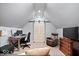 Attic office space with desk, chair, television and barn door at 1621 Rosebud Ln, Greenwood, IN 46143