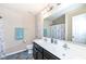 Bathroom featuring double sinks, a large mirror, vanity lighting, and a shower curtain at 16406 Taconite Dr, Noblesville, IN 46060