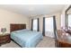 Bedroom with carpet, neutral walls, a bed, nightstand, dresser, and a window with curtains at 16406 Taconite Dr, Noblesville, IN 46060