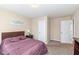 Cozy bedroom featuring a bed with a wooden headboard, a nightstand and neutral colored walls at 16406 Taconite Dr, Noblesville, IN 46060
