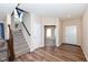 Inviting entryway with wood flooring, a staircase, and a view into the adjacent room at 16406 Taconite Dr, Noblesville, IN 46060