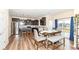 Modern kitchen with stainless steel appliances, dark wood cabinetry, and a dining area at 16406 Taconite Dr, Noblesville, IN 46060