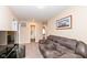 Living room showing a plush couch and TV on a console; an open doorway leads to the bathroom at 16406 Taconite Dr, Noblesville, IN 46060