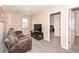 Living room featuring a comfortable couch and a TV, leading to an adjacent bedroom at 16406 Taconite Dr, Noblesville, IN 46060