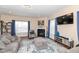 Bright living room with a fireplace, large windows, and comfortable seating at 16406 Taconite Dr, Noblesville, IN 46060