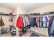 Carpeted walk-in closet with shelving and hanging rods for storing clothes and shoes at 16406 Taconite Dr, Noblesville, IN 46060