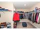 Walk-in closet with carpeted floor, shelving, hanging rods, and a padded stool at 16406 Taconite Dr, Noblesville, IN 46060