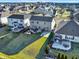 Lovely aerial view of backyards featuring patios, fire pits, and well-manicured lawns in a Gathering-friendly neighborhood at 16736 Workington Way, Westfield, IN 46074