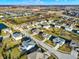 Expansive aerial view of a suburban neighborhood with well-maintained homes and green spaces under a bright, clear sky at 16736 Workington Way, Westfield, IN 46074