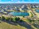 Stunning aerial shot of a serene pond surrounded by lush greenery and a well-planned residential neighborhood at 16736 Workington Way, Westfield, IN 46074