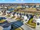 Aerial view of the neighborhood showcasing the home, street, and nearby pond at 16736 Workington Way, Westfield, IN 46074