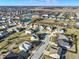 Beautiful aerial shot of a residential area featuring charming homes, winding streets, and a tranquil neighborhood pond at 16736 Workington Way, Westfield, IN 46074