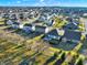 Panoramic aerial view of a large suburban neighborhood with diverse home styles and mature trees casting long shadows at 16736 Workington Way, Westfield, IN 46074