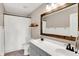 Well-lit bathroom with a double vanity, framed mirror, and shower featuring a clean and modern design at 16736 Workington Way, Westfield, IN 46074