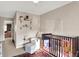 Charming Bedroom with a dark wooden crib, comfortable chair, and bookshelves displaying toys and books at 16736 Workington Way, Westfield, IN 46074