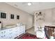 Bright Bedroom with a white dresser and changing station, complemented by tasteful artwork and a comfortable chair at 16736 Workington Way, Westfield, IN 46074