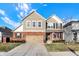 Inviting two-story home featuring a brick facade, siding, attached garage, and well-maintained landscaping at 16736 Workington Way, Westfield, IN 46074