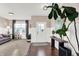 Bright foyer featuring hardwood floors, paneled walls, and a decorative console table with a large plant at 16736 Workington Way, Westfield, IN 46074