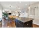 Open kitchen view highlighting granite counters, center island, and seamless flow to the dining and living areas at 16736 Workington Way, Westfield, IN 46074