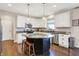 Bright kitchen featuring white cabinets, granite countertops, stainless steel appliances, and a center island at 16736 Workington Way, Westfield, IN 46074