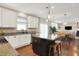 Kitchen with island seating, granite countertops and open floor plan to living spaces at 16736 Workington Way, Westfield, IN 46074
