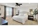 Comfortable main bedroom featuring a ceiling fan, carpet, and large window providing natural light at 16736 Workington Way, Westfield, IN 46074