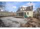 Backyard view of a charming home with a sunroom addition and mature trees for privacy at 1711 Kessler E Blvd, Indianapolis, IN 46220