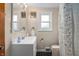 Bathroom with a vanity sink, floral accents and decor, and natural light from the window at 1711 Kessler E Blvd, Indianapolis, IN 46220
