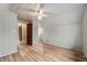 Cozy bedroom with paneled walls, hardwood floors, and an open doorway into the rest of the house at 1711 Kessler E Blvd, Indianapolis, IN 46220
